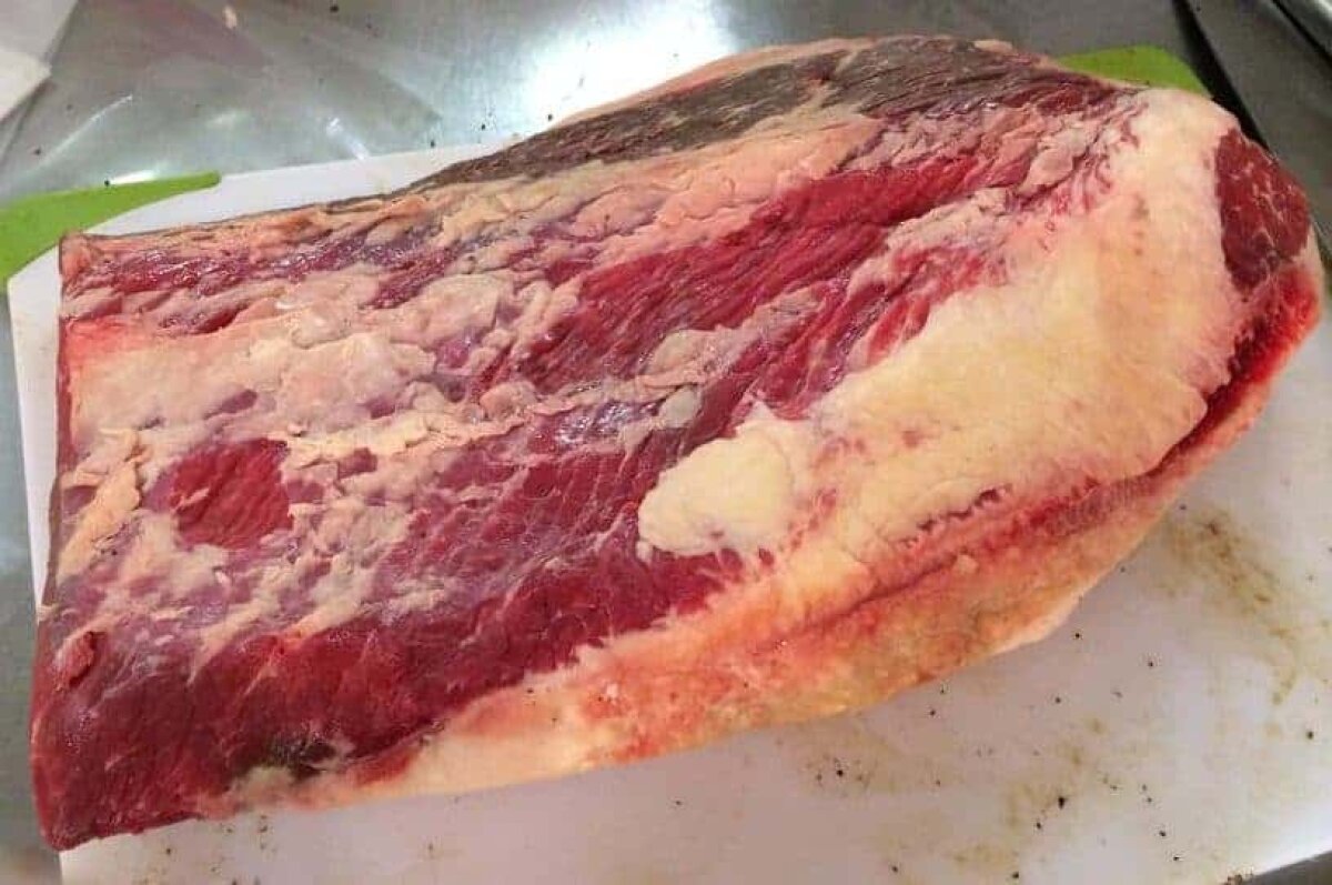 Whole packer beef brisket showing the lean flat and marbled point before trimming
