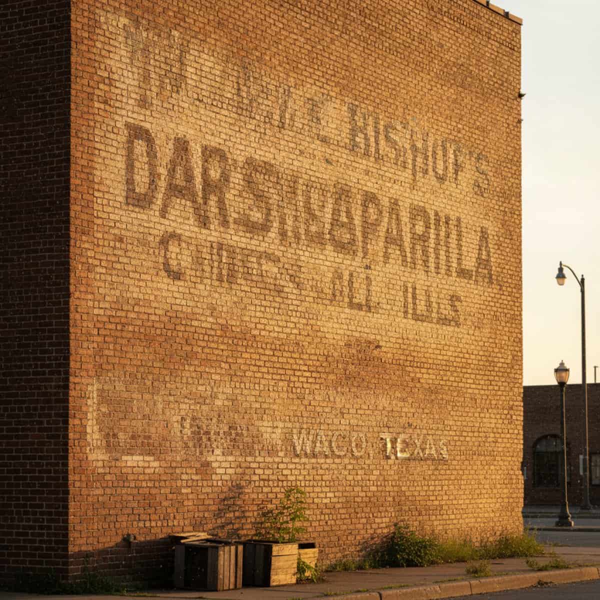 Faded ghost sign on a brick building.