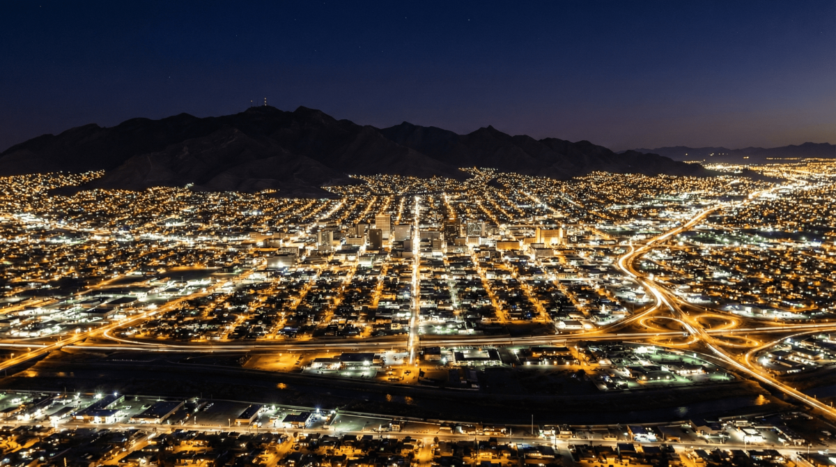 Downtown El Paso after dark, with the Franklin Mountains keeping watch overhead and Juárez glowing just beyond the river. This city has seen a lot. It's still standing, and it's not going anywhere.